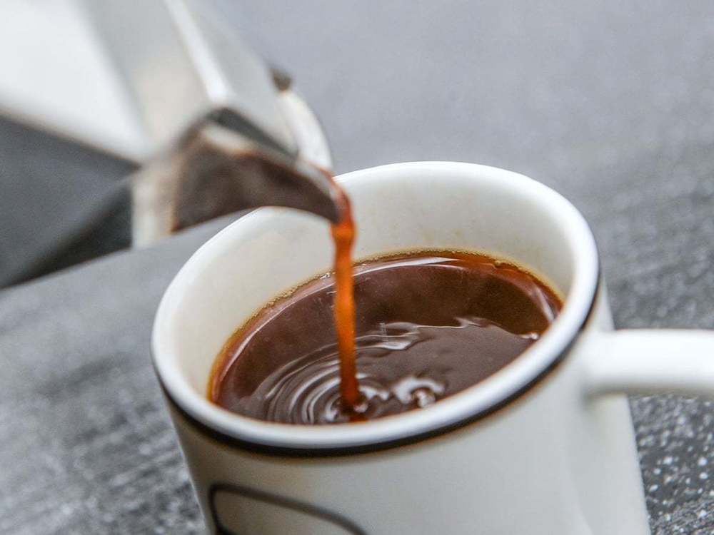 Cup of coffee being poured